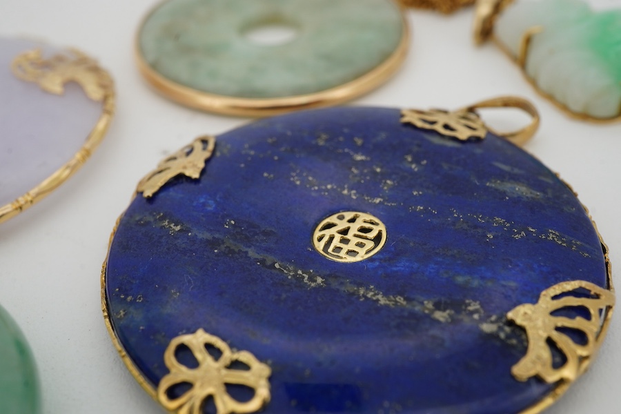 A collection of Chinese jewels, including three disc shaped pendants in pale lavender and green jadeite, mounted in gold, longest 4.6cm including bail; another disc-shaped pendant in lapis lazuli, mounted in gold; and a
